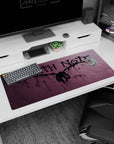 Winged shinigami silhouette centered on Death Note anime desk pad 36x16 inches with splatter lines.