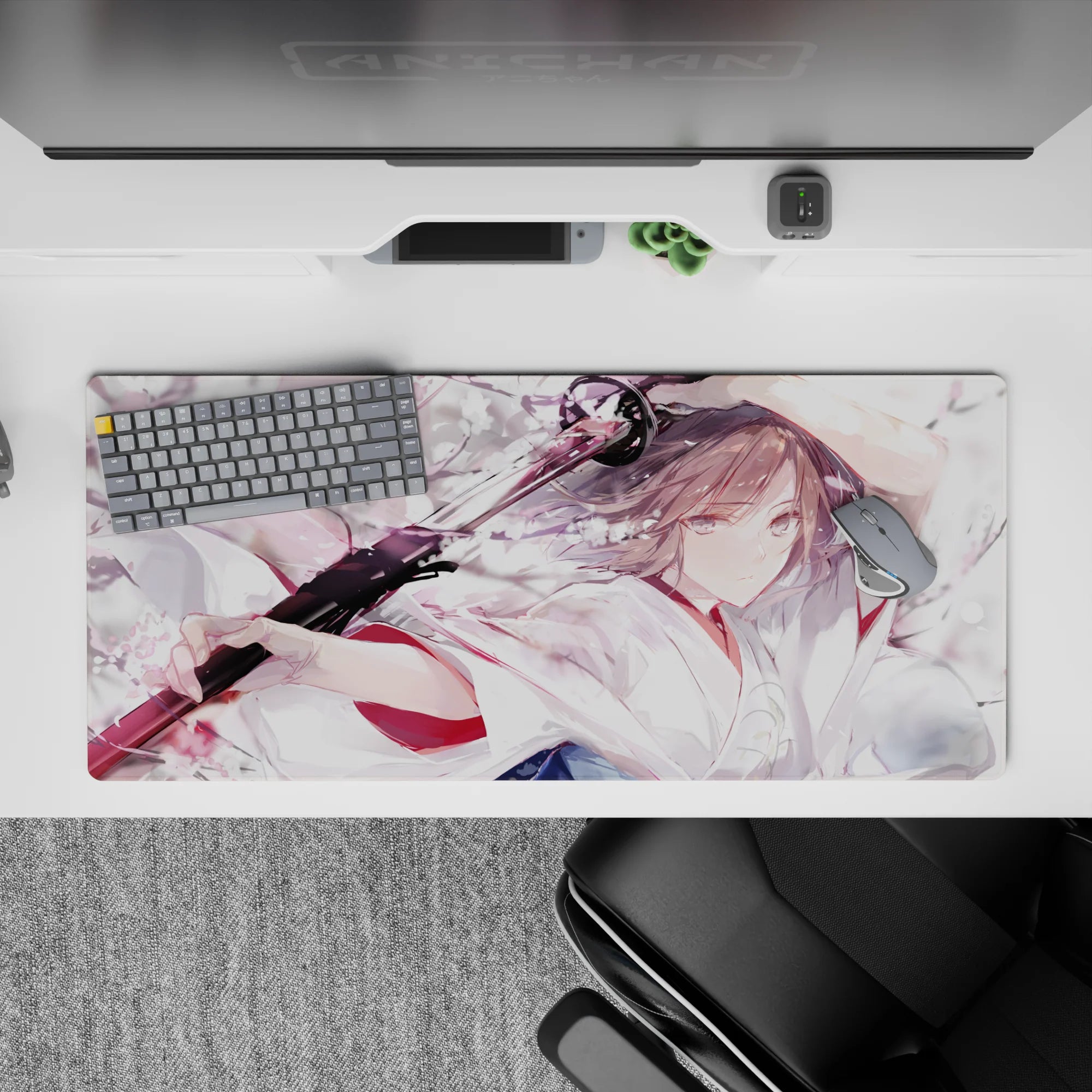Watercolor anime desk pad 36x16 inches in pale pink, milky white, smoky gray, with bold black blade contrast.