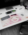 Pink-haired anime girl with eyes closed and cheeks squished into a grin desk pad 36x16 inches.