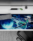 Moody navy and aqua anime desk pad 36x16 inches with bright full moon glow and icy blue splashes.
