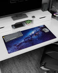 Star-filled galaxy ribbon scene mouse pad 32x16 inches with misty blue clouds across dark space.