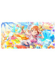 32x16 inches anime girl mouse pad with winking orange-haired girl, water blaster, ribbons, stars, and splashes.