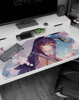 Violet-haired anime girl under a rain umbrella with sakura confetti desk pad 40x20 inches.