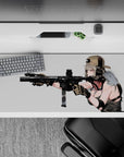 36x16 inches anime desk pad in soft silver hair tones and warm blush, with dark tactical gear contrast.