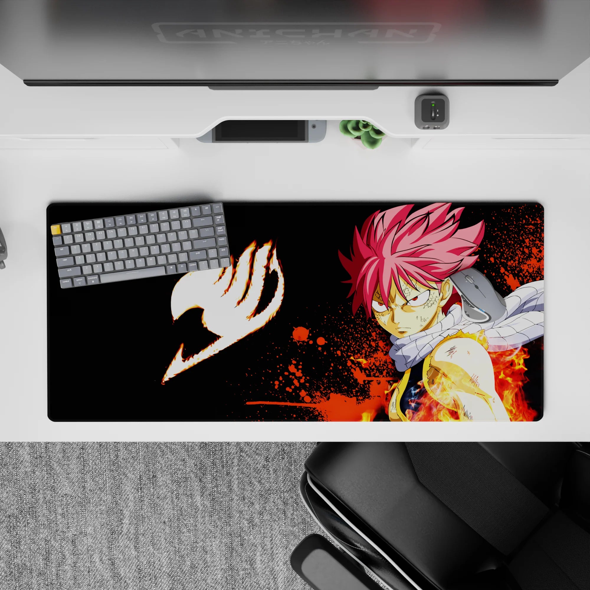 36x16 inches anime desk pad in deep black with orange splatter flames, intense fiery battle mood.