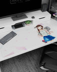40x20 inches anime desk pad featuring a glossy-eyed girl waving, chestnut pigtails, floral top.