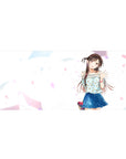 36x16 inches anime girl desk pad with smiling twin-tail girl, floral top, blue skirt, pastel confetti.