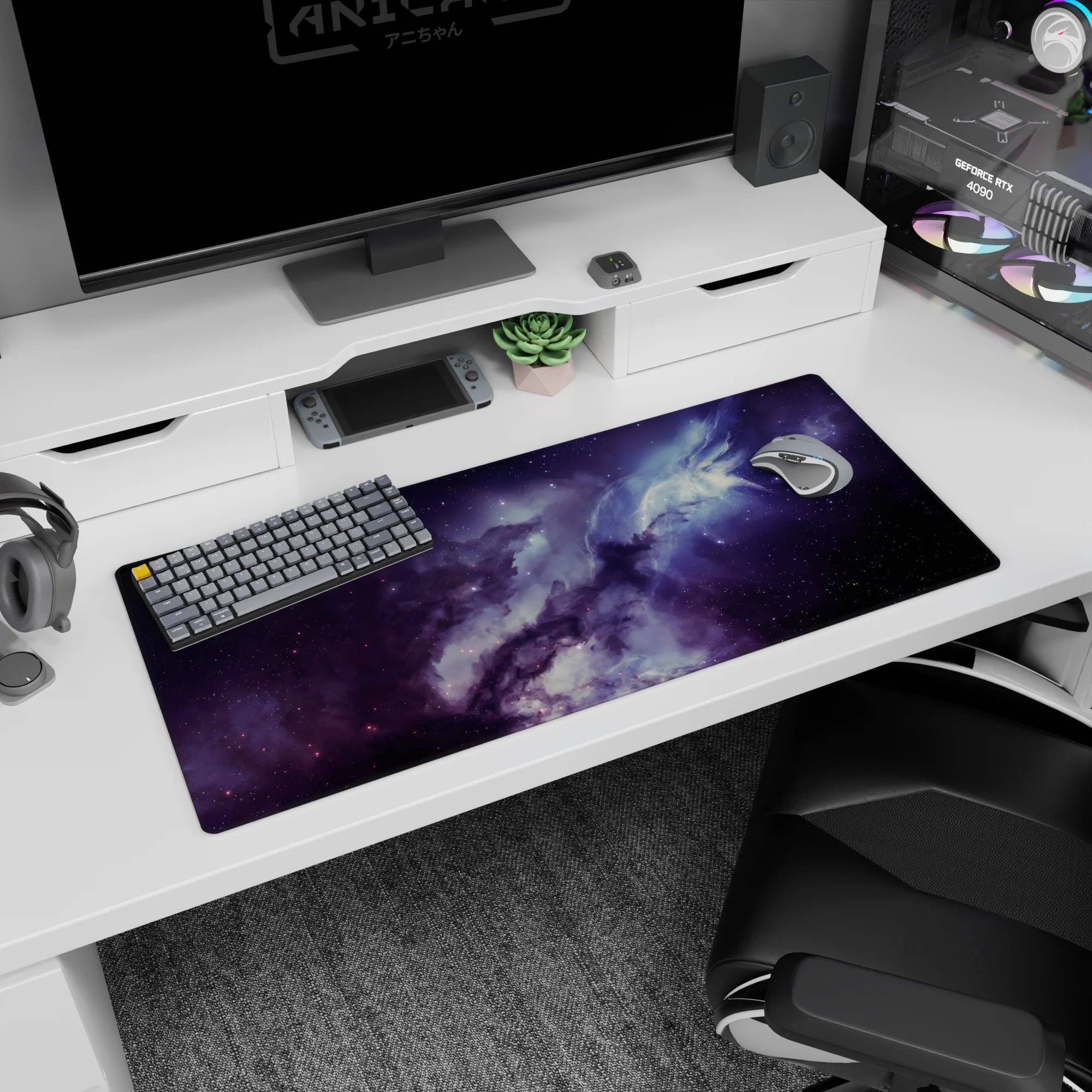 Nebula clouds swirling with tiny star specks across a space scene desk pad, 36x16 inches.