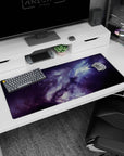 Nebula clouds swirling with tiny star specks across a space scene desk pad, 36x16 inches.