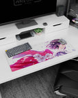 32x12 inches desk mat showing smiling anime girl in breeze, glossy pink ribbon trailing through cherry blossoms.