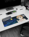 Big-eyed anime girl desk mat 32x12 inches, pink cheeks and sandy hair, flashing peace signs on dark swirls.