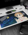 Big-eyed anime girl desk pad 40x20 inches with pink cheeks, sandy hair, and double peace pose.