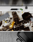 High-contrast anime desk pad 40x20 inches in smoky blacks and whites with warm brass accents, intense mood.