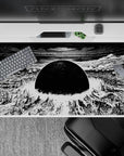 Monochrome 40x20 inches anime desk pad, high-contrast black and white with tense apocalyptic calm.