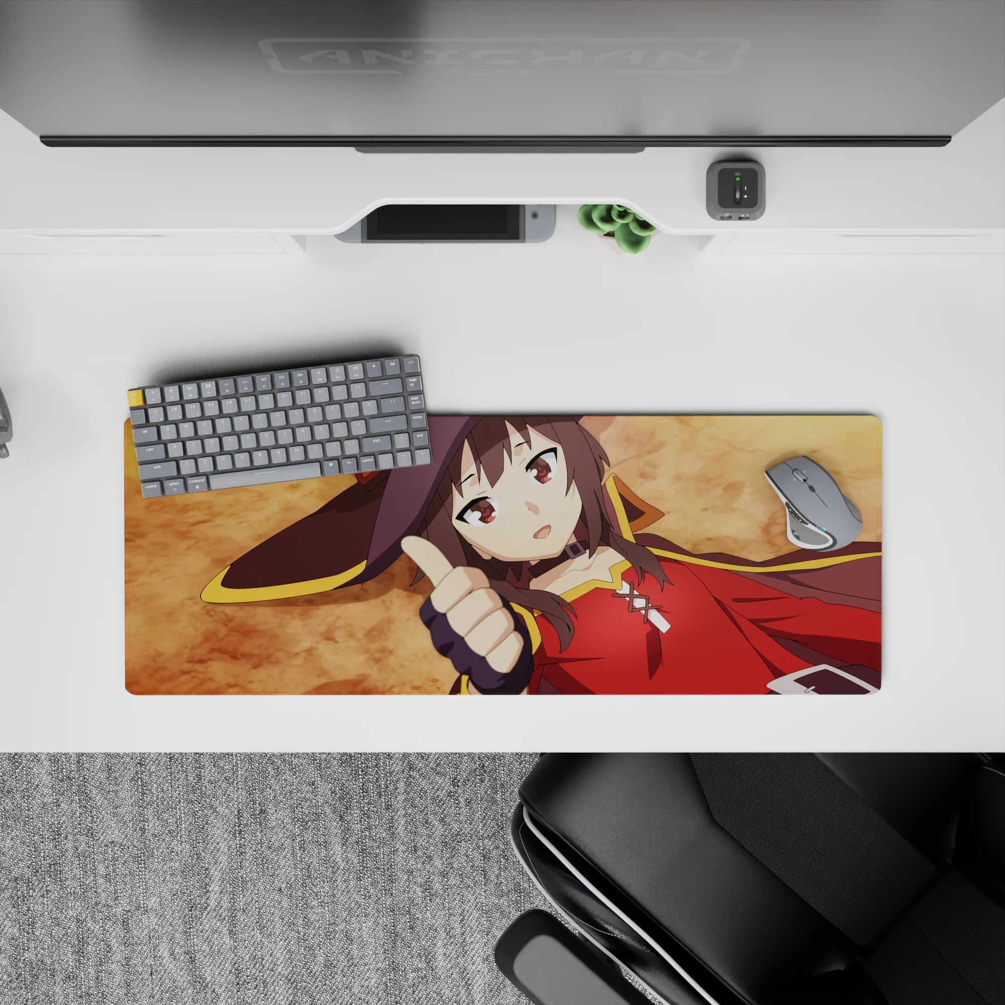 Megumin from KonoSuba laying flat, thumbs up on a 32x12 inch mouse pad, showcasing her crimson cloak and witch hat.
