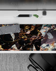 Cinematic anime desk pad 36x16 inches in smoky blues with orange sparks, bronze chains, and action energy.