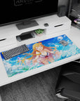 Laughing blonde anime girl with flower ribbon hair clip on ocean backdrop desk pad 36x16 inches.