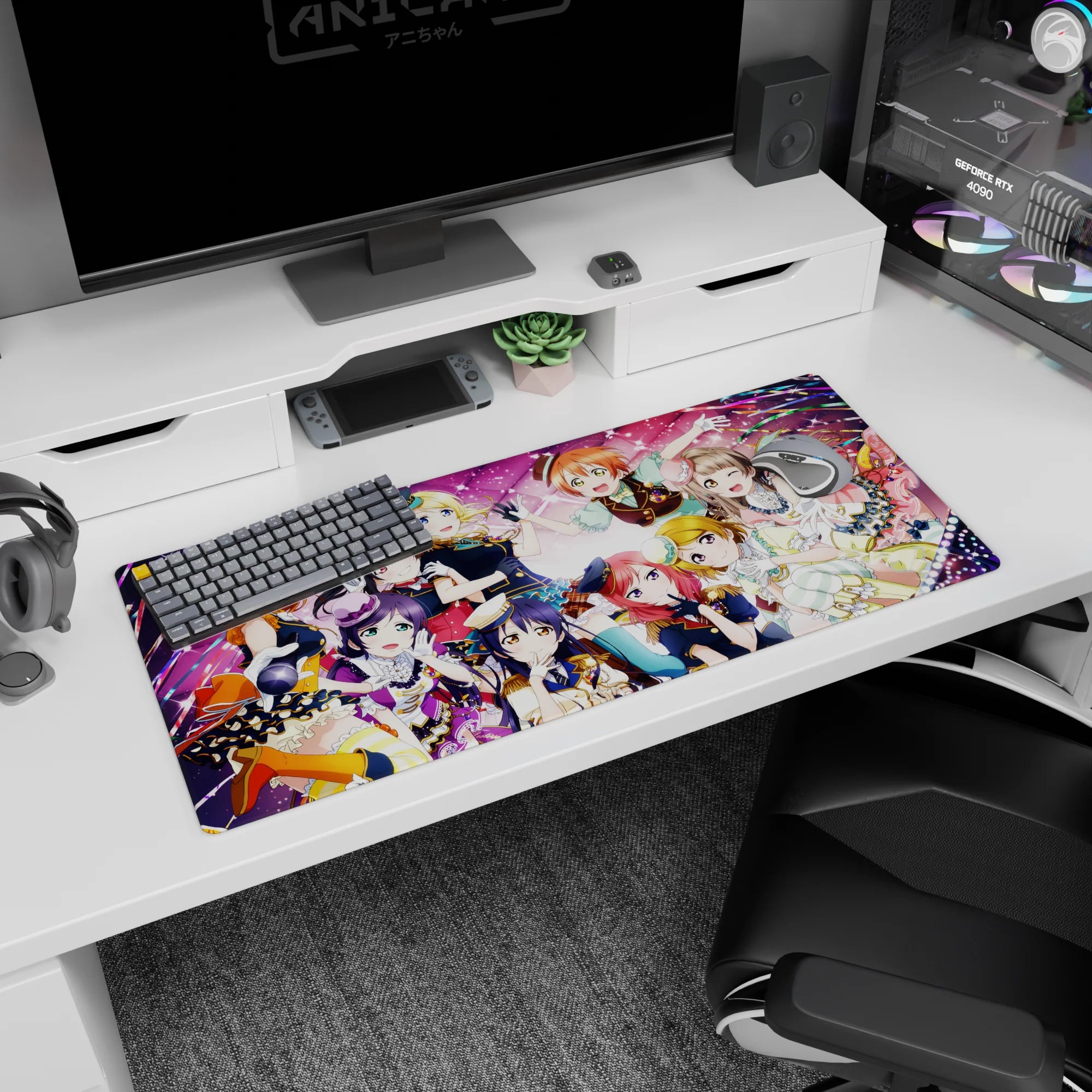 Honoka, Umi, and Kotori in a sparkly idol group hug scene anime girl desk pad, 36x16 inches.