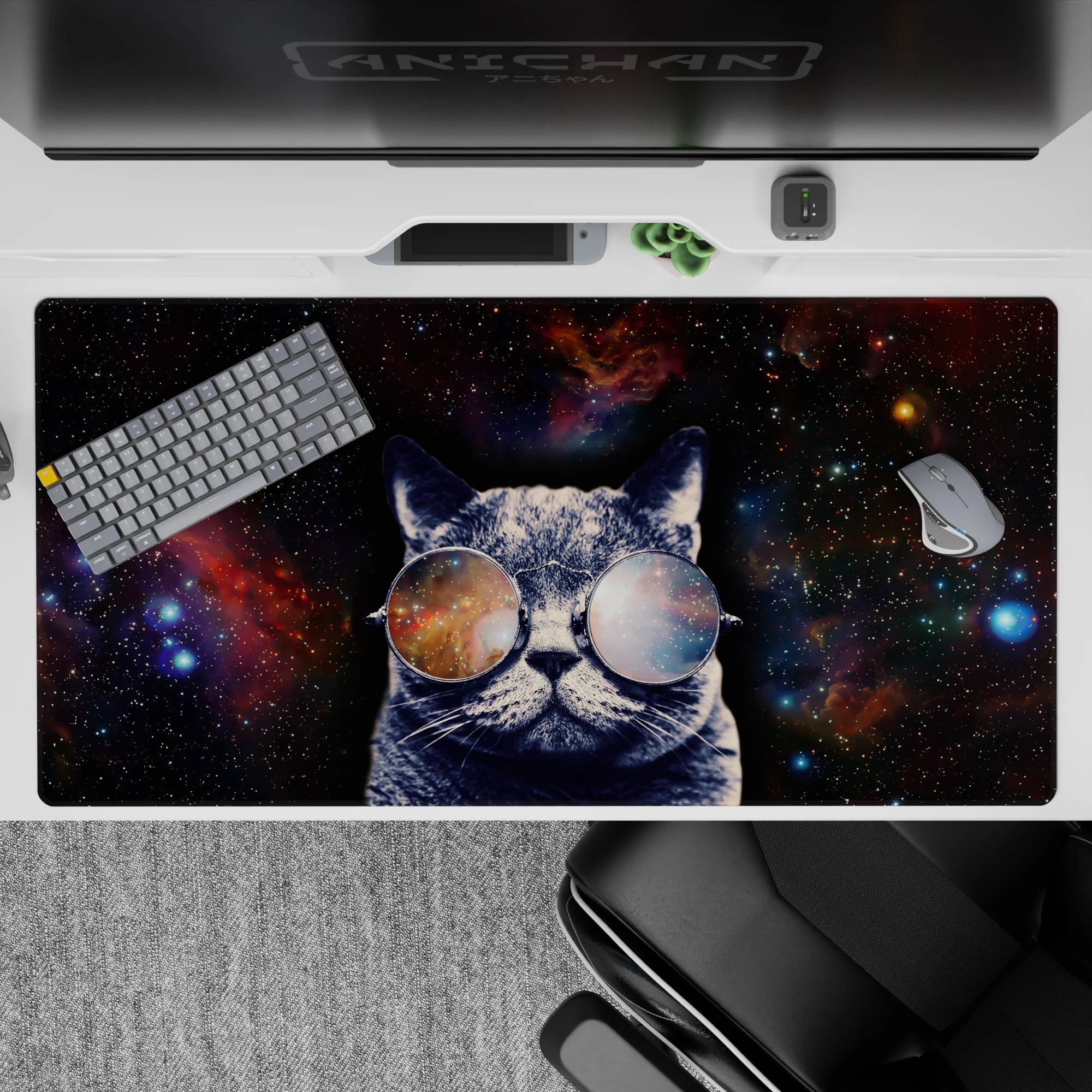 Cosmic desk pad 40x20 inches in midnight black with purple, teal, and warm nebula orange sparkles.