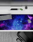 Velvety purple and electric blue cosmic desk pad, 36x16 inches, calming night-sky vibe with stars.