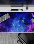 Velvety purples and electric blues galaxy desk pad 40x20 inches, calming night-sky mood.