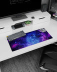 Swirling nebula clouds and tiny stars across a deep-space scene on a 28x12 inches mouse pad.