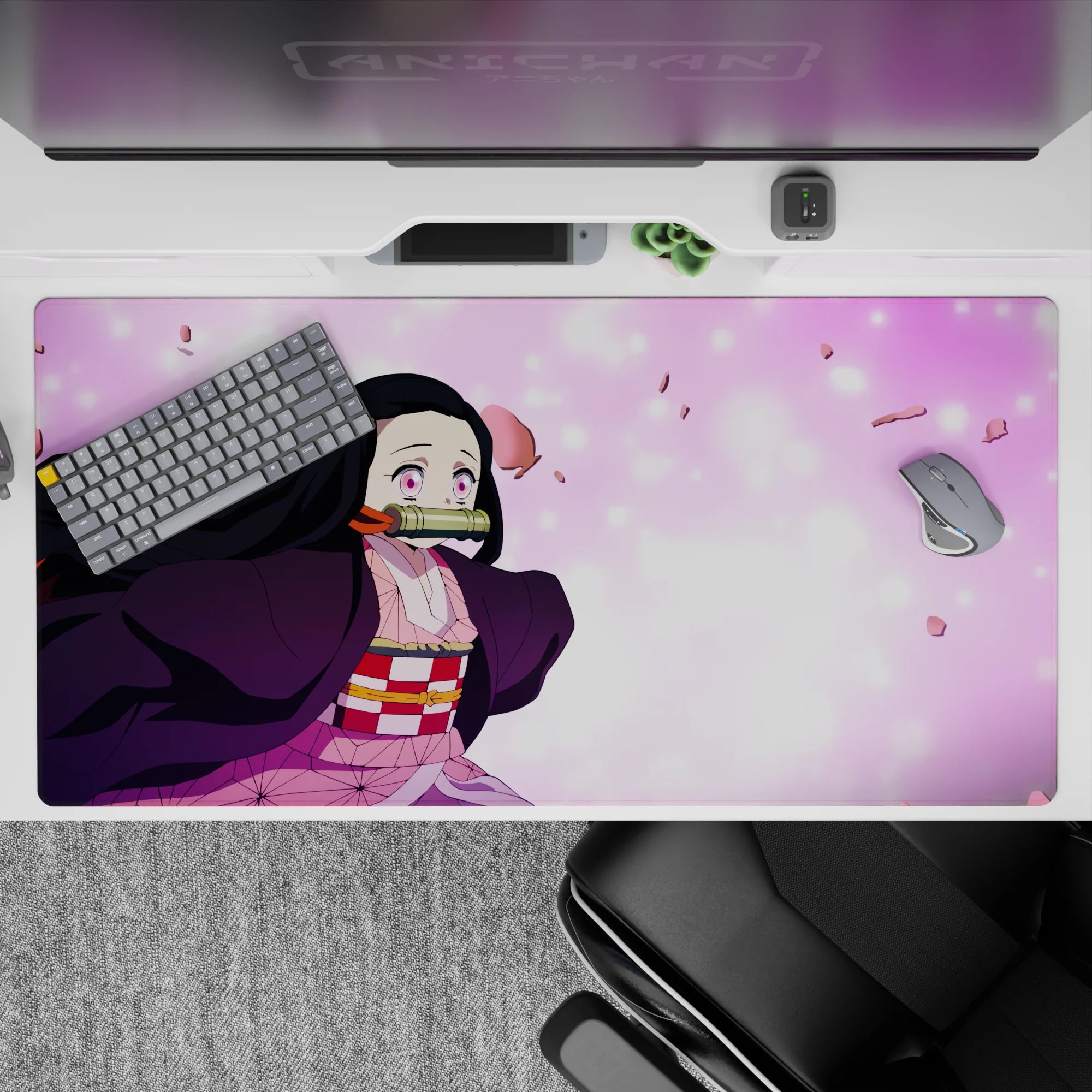 Nezuko 40x20 inch anime desk pad with pink sakura petals, vibrant eyes, and pastel tones, capturing her fierce charm.