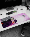 Anime mouse pad 36x16 inches featuring Nezuko from Demon Slayer, with sakura petals and pastel tones for a vibrant design.