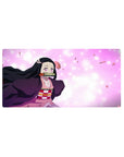 Anime mouse pad 32x16 inches featuring Nezuko from Demon Slayer, highlighted by sakura petals and pastel tones.