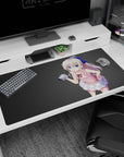 Shy silver-haired anime girl holding a tiny camera on desk pad 40x20 inches, huge blue eyes, pout.