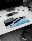 Silver spaceship cruising over cloud swirls and ocean blues on a 28x12 inches extended mouse pad.
