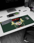 36x16 inches desk pad showing mischievous blonde anime girl staring forward, grinning in dark cap.