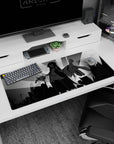 Anime girl reaches out over a skyline on desk pad 36x16 inches, flowing sleeves and ink-black hair.