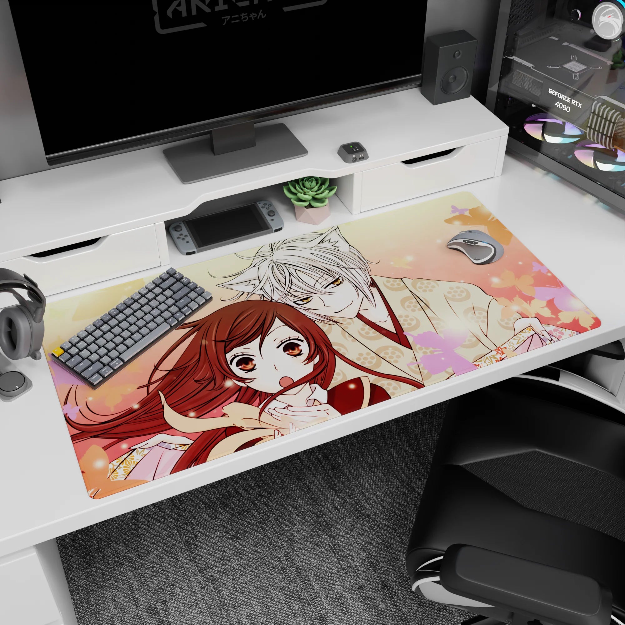 Anime desk pad 40x20 inches showing fox boy in paw-print kimono leaning close to scarfed girl under sakura.