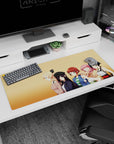 36x16 inches anime desk pad featuring blonde girl with bow and pink-haired wink, plus cute friends.