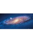 Cosmic spiral galaxy desk pad 36x16 inches with star-speckled swirl design for keyboard and mouse.