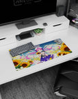 28x12 inches anime girl mouse pad featuring a cute idol in pink twin-tails amid drifting petals and sunflowers.