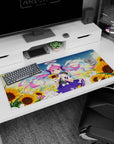 36x16 inches anime girl desk pad showing pink twin-tail sailor girl by sunflowers, petals drifting under blue sky.