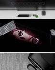 Dark moody anime desk pad 40x20 inches with deep blacks, rosy highlights, and candy pink eyes.