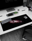 Close-up anime girl peeking from the dark with candy pink eyes on a 36x16 inches extended desk pad.