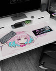 Riamu Yumemi shy-brave pose tugging her pink hair on an anime desk pad 40x20 inches.