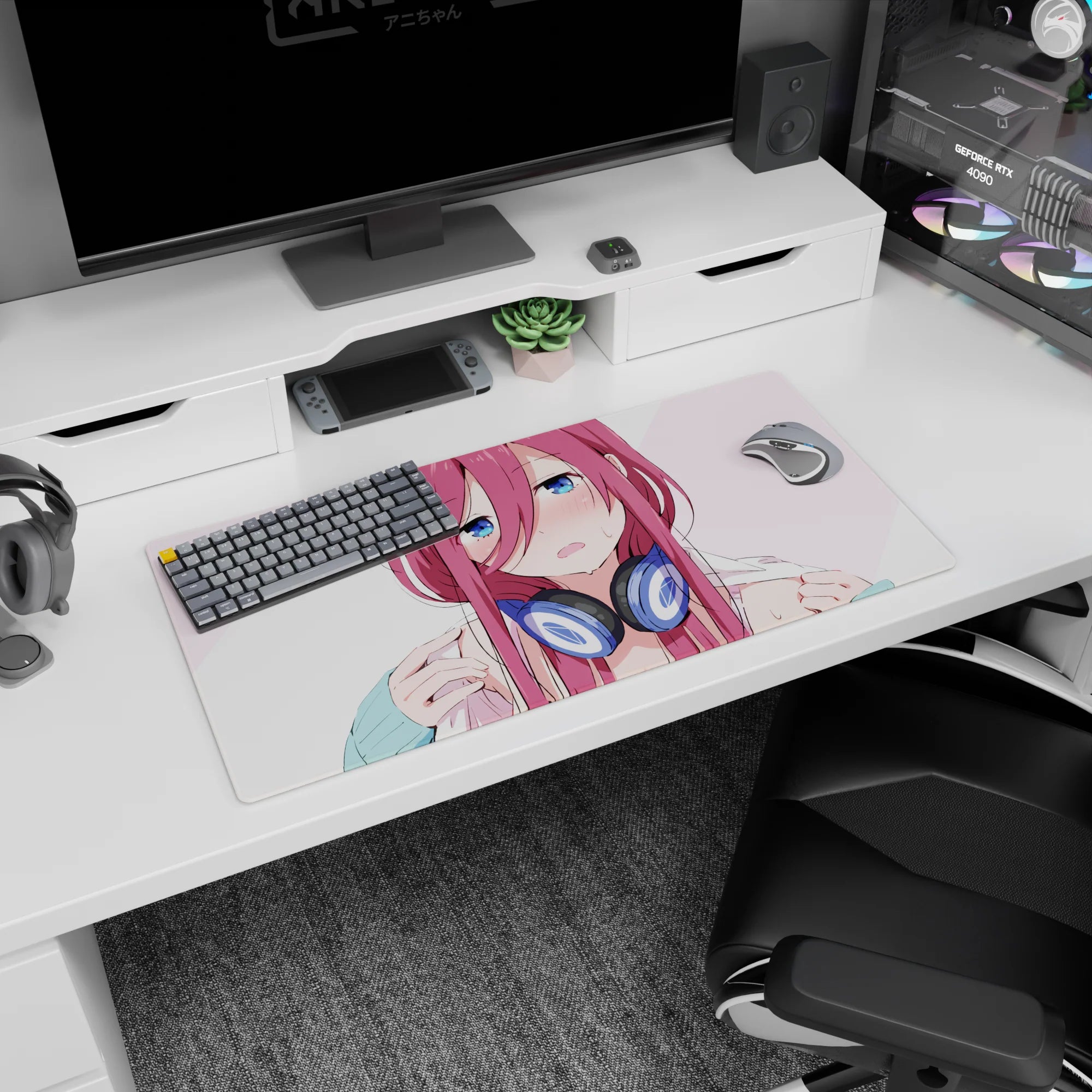 32x16 inches anime girl desk mat featuring flustered pink-haired girl pausing your music in chunky navy headphones.