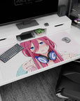 Flustered pink-haired anime girl in navy headphones on a 40x20 inches desk pad, staring with big blue eyes.