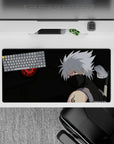 32x16 inches anime mouse pad in smoky blacks and deep greens with red Sharingan glow, chill fierce vibe.