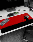 Lone cloaked swordsman with wind-whipped scarf in tall black grass, 40x20 inches anime desk pad.