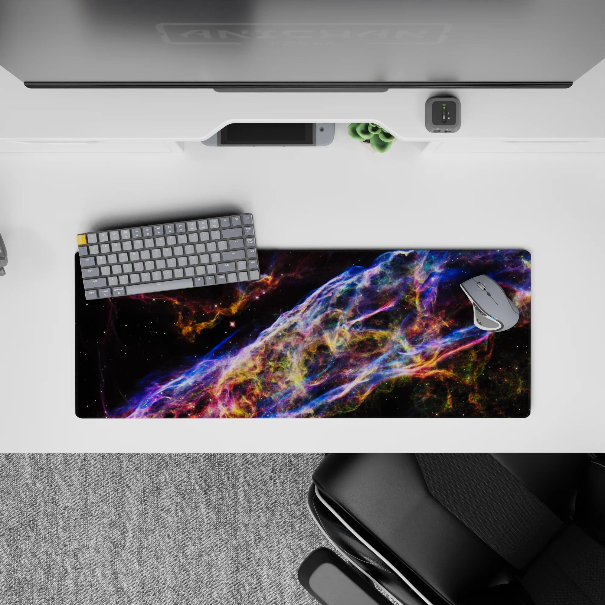 Neon blue, violet, and ember-orange swirls on a dark space mouse pad, 32x12 inches, moody glow.