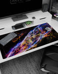 Deep space scene desk pad with neon ribbon swirls and tiny stars scattered throughout, 40x20 inches.
