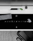 Matte black anime desk pad with bright white line art, minimalist ninja icons, 36x16 inches.