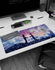 Anime desk pad 36x16 inches showing hooded teens reaching hands on a cloud ridge, light snapping between.