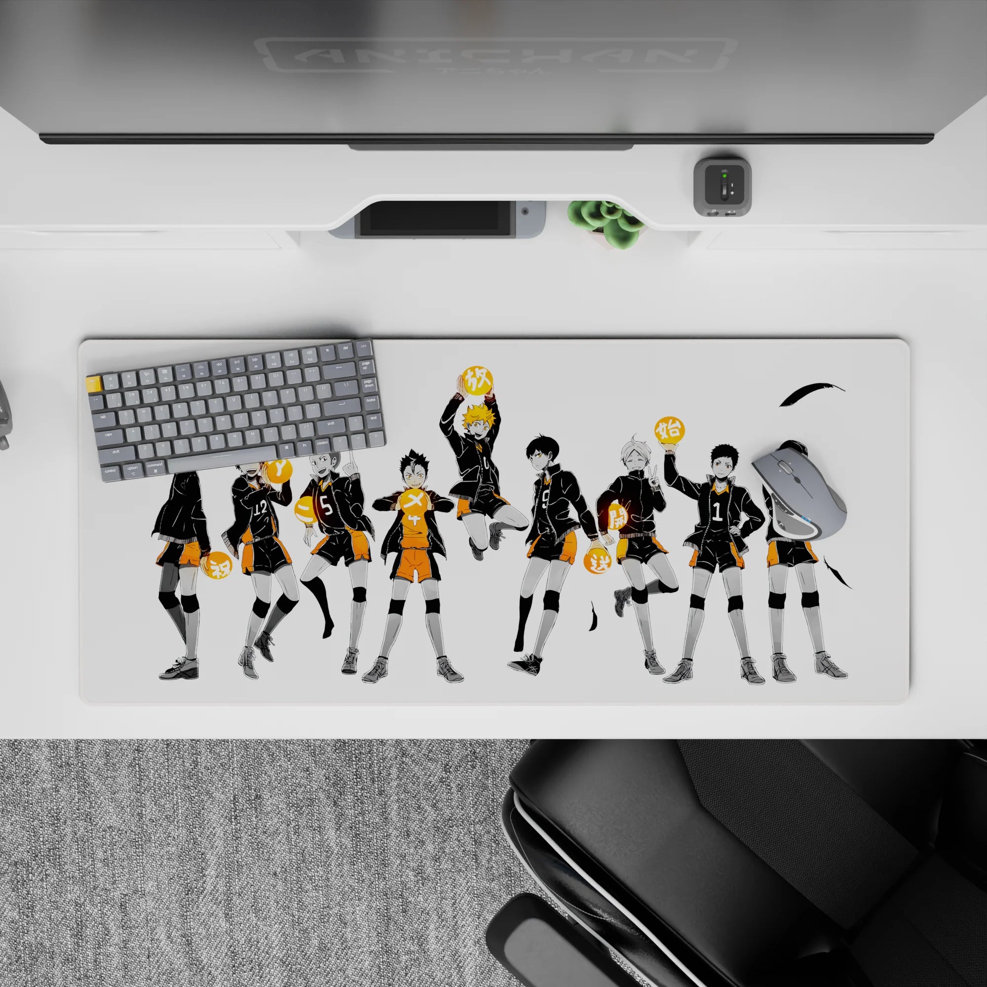 Dramatic black-and-orange volleyball desk pad 36x16 inches on clean white background, bold and tidy.